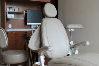 Dentist office with beige dental chair.