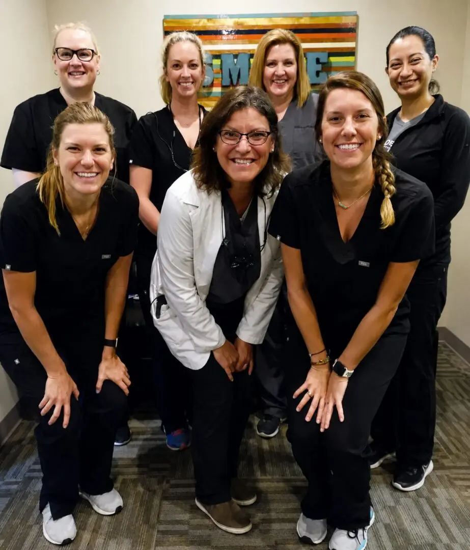 Group of smiling medical professionals posing together.