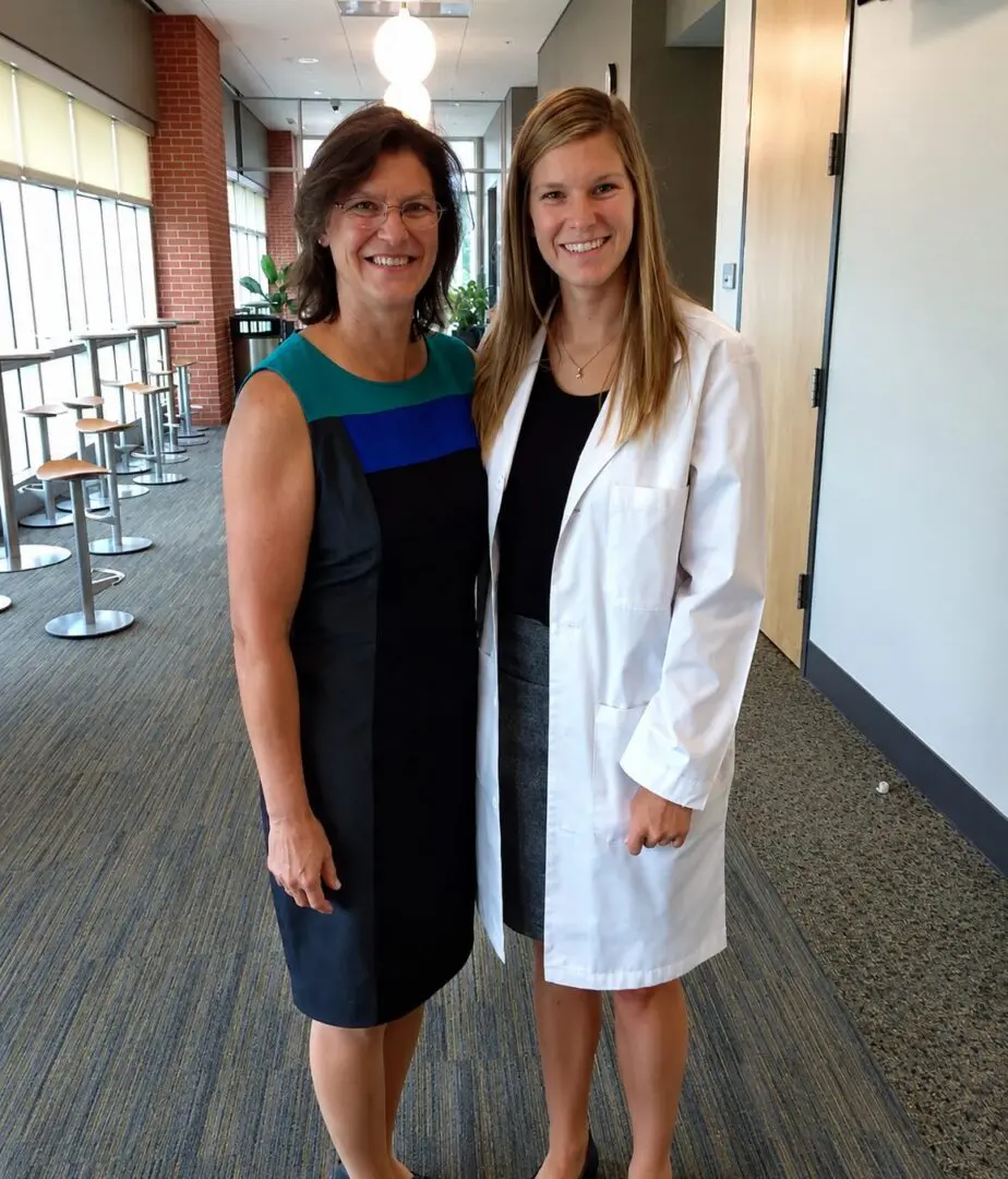 Two women smiling in an office setting.