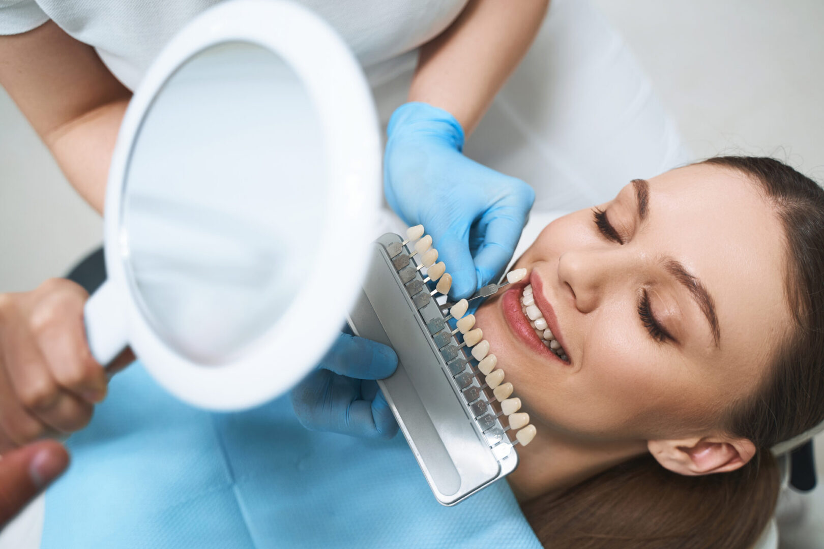 Woman smiling during dental shade matching.